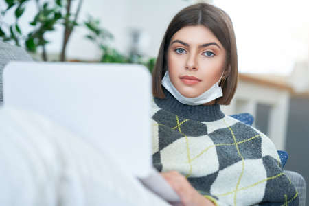 Teenage girl having online classes at homeの写真素材