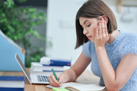 Teenage girl having online classes at home