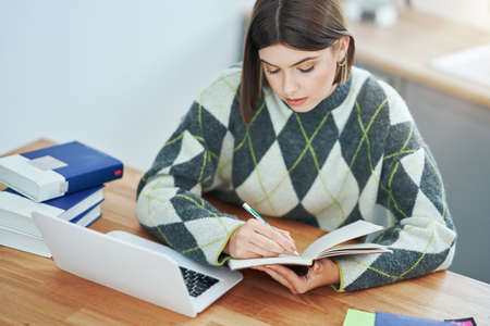 Teenage girl having online classes at home