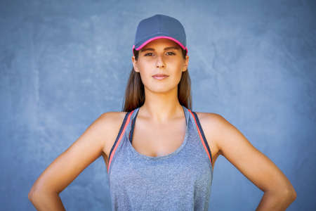 Female runner posing over gray backgroundの写真素材