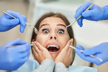 Male dentist and woman in dentist officeの写真素材