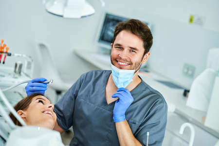 Male dentist and woman in dentist officeの写真素材