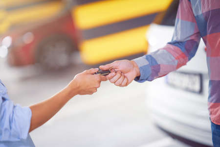 Car dealer giving keys to a customerの写真素材