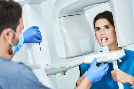 Dentist taking a panoramic digital xray of a patients teethの写真素材