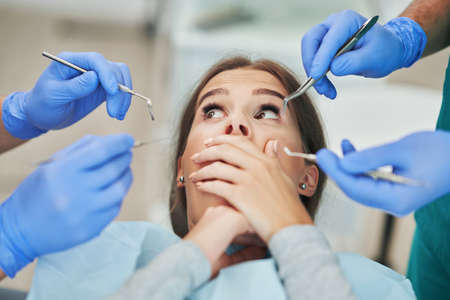 Male dentist and woman in dentist officeの写真素材