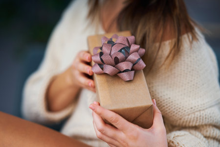 Adult woman with Christmas present at home