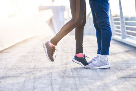 Adult couple jogging in the city in masks during lockdownの写真素材