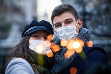 Happy couple celebrating Valentines Day in masksの写真素材
