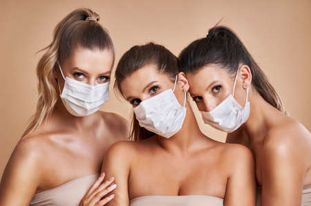 Diverse group of women in masks isolated over backgroundの写真素材