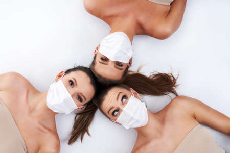 Diverse group of women in masks isolated over backgroundの写真素材