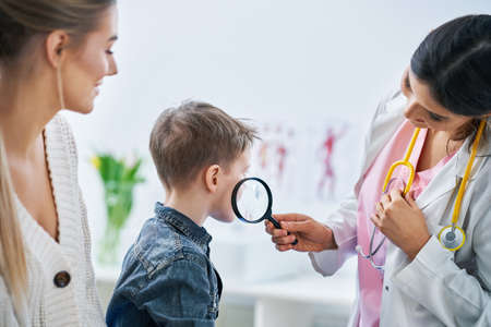 Little boy having medical examination by dermatologistの写真素材