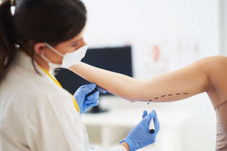 Plastic surgeon consulting a female patientの写真素材