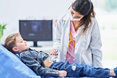 Little boy having USG examination by pediatrician