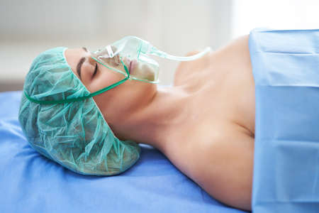 Female patient having respiratory therapy recovering in the hospitalの写真素材