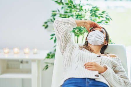 Adult woman in mask during appointment with psychologistの写真素材