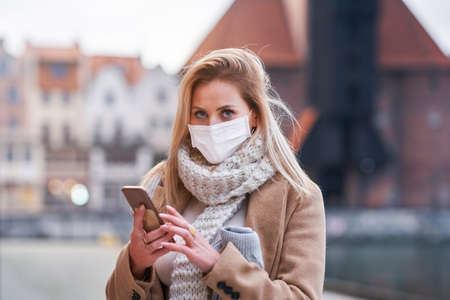 Woman wearing face mask because of Air pollution or virus epidemic in the city