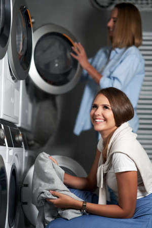 Two students in laundry roomの写真素材