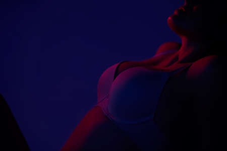 Sexy woman shape posing over red dark background