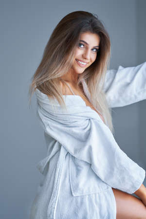 Beautiful woman in bathrobe in the morning