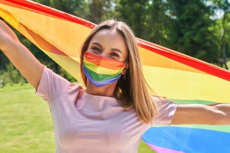 Woman wearing lgbt flag outdoor.