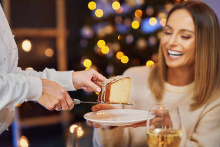 Friends celebrating christmas party holding wine