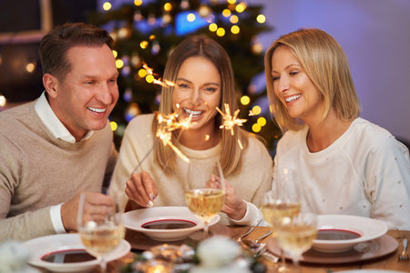 Friends celebrating christmas party holding sparklersの写真素材