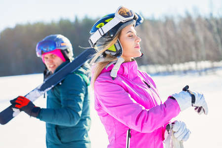 Young couple having fun while winter skiingの写真素材
