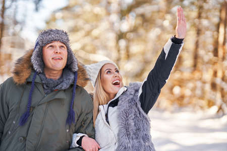 Couple having fun in winter scenery and snow