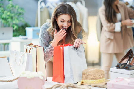 Nice woman on shopping in clothes storeの写真素材