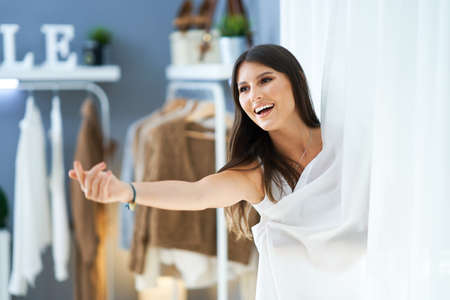 Woman in clothes store in changing roomの写真素材