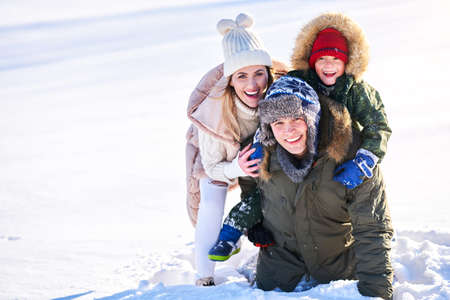 Nice happy family having fun on winter snowの写真素材