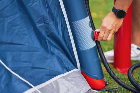 Young nice couple having fun on camping setting up tent