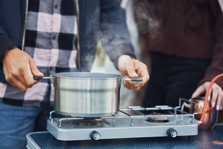 Young nice couple having fun on camping while cooking and eatingの写真素材