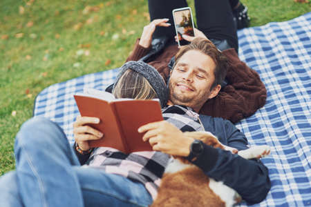 Young nice couple having fun on camping with dog