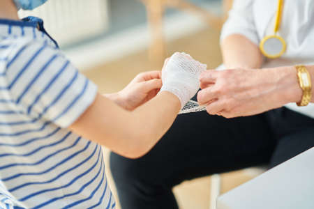 Pediatrician doctor examining little kids in clinic