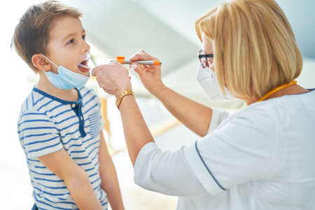 Pediatrician doctor examining little kids in clinic