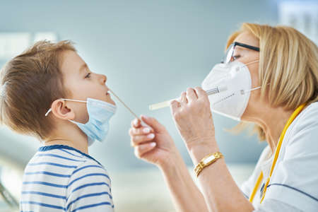 Pediatrician doctor examining little kids in clinic