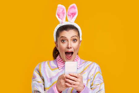 Studio shots of woman over yellow background easter style