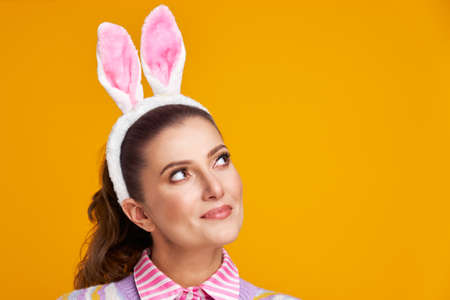 Studio shots of woman over yellow background easter style