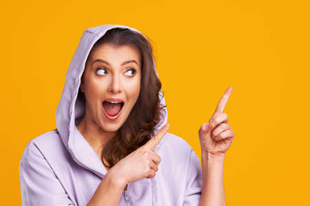 Young nice woman isolated over yellow backgroundの写真素材