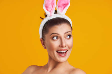 Young nice woman isolated over yellow backgroundの写真素材