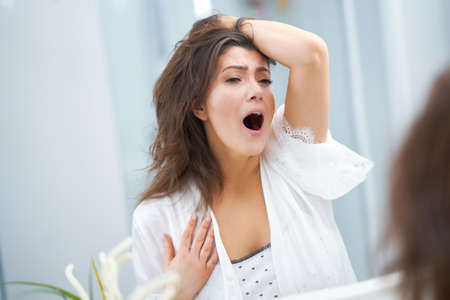 Young nice brunette woman in the bathroom