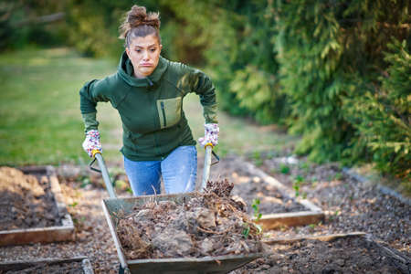 Picture of tired woman working with tools in the garden