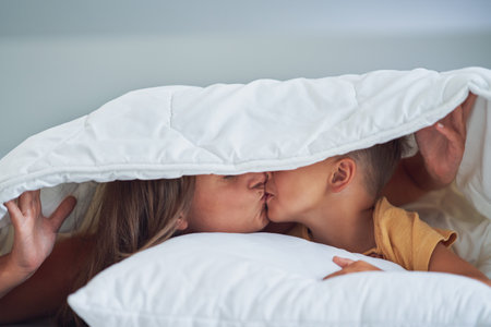 Young mother with 4 years old son in bed