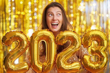 Women at new year party with gold balloons