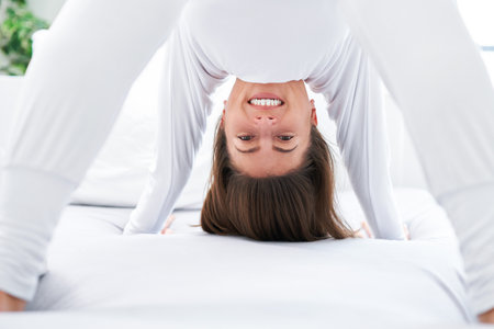 Nice female in bed relaxing or doing yoga