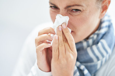Young brunet woman sick in the bed with tissue