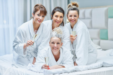 Girls with wine at spa party in the hotelの写真素材