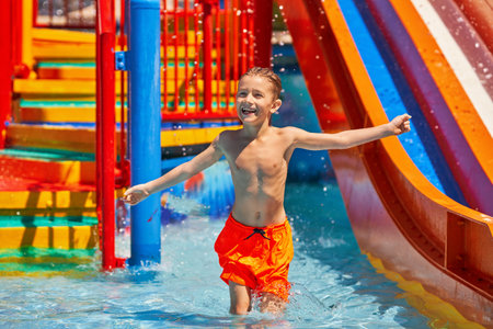 Picture of young boy playing in outdoor aqua parkの写真素材