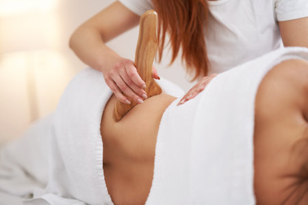 Woman at massage therapy with wooden toolsの写真素材